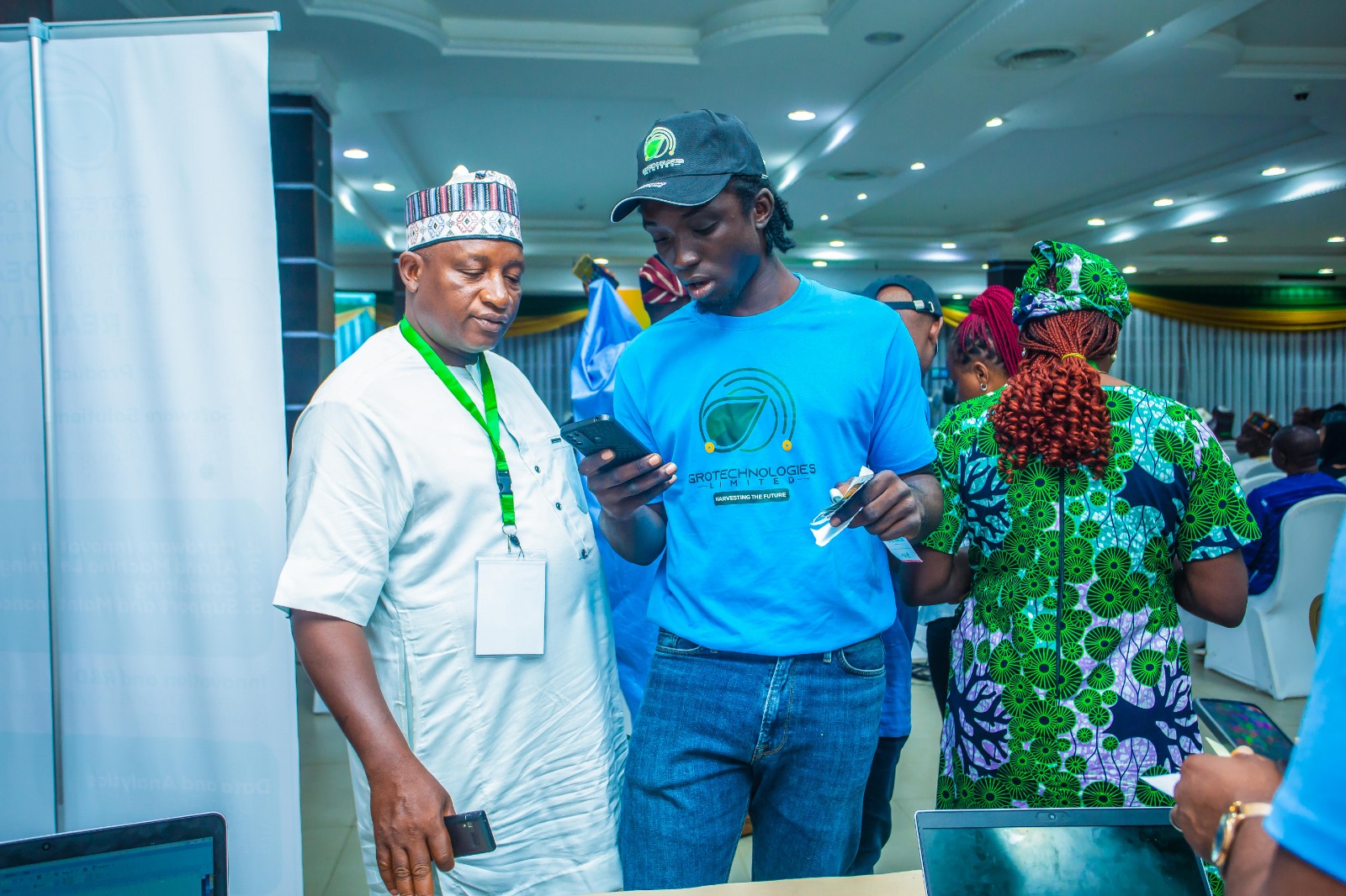 Team member demonstrating app to delegate at conference