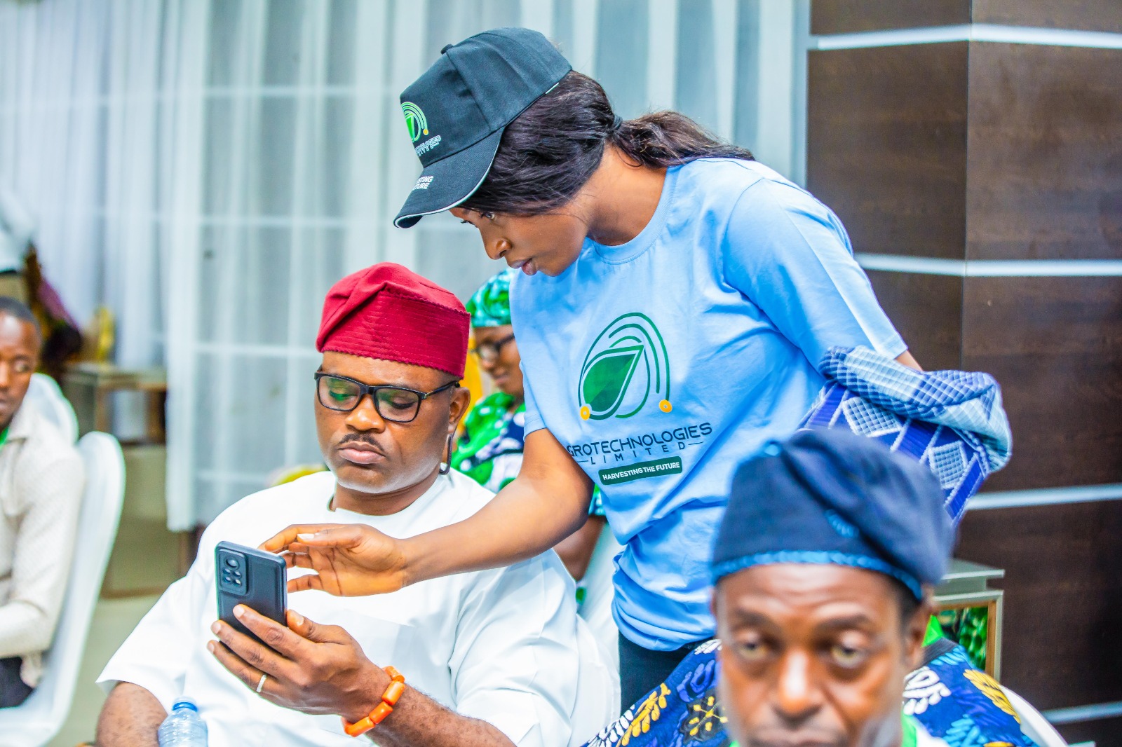 Team member helping farmer with app onboarding