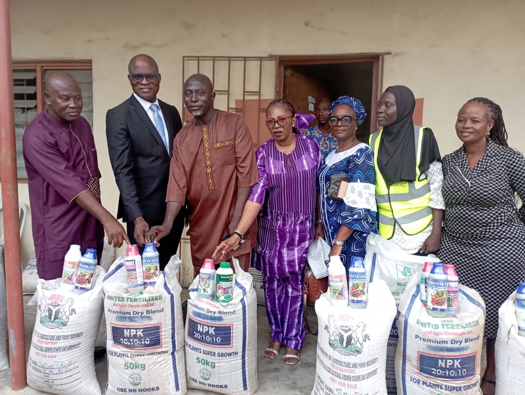 Officials and farmers with NPK fertilizer bags distribution
